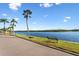 Peaceful waterfront path with benches and palm trees at 611 Destiny Dr # 107, Ruskin, FL 33570