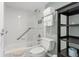 Clean bathroom with shower/tub combo, toilet and shelving at 611 Destiny Dr # 107, Ruskin, FL 33570