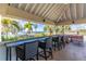 Covered patio with seating area overlooking the water at 611 Destiny Dr # 107, Ruskin, FL 33570