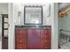 Dark wood vanity with granite countertop in the bathroom at 611 Destiny Dr # 107, Ruskin, FL 33570