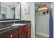 Clean bathroom with granite countertop and built-in storage at 611 Destiny Dr # 107, Ruskin, FL 33570