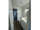 Clean bathroom featuring a white vanity, updated fixtures, and vinyl flooring at 10294 Reims Ave, Englewood, FL 34224