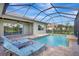 Relaxing screened pool with lounge chairs at 16806 1St E Ave, Bradenton, FL 34212