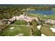 Aerial view of upscale community with golf course, clubhouse, and lake at 21 Bayhead Ln, Osprey, FL 34229