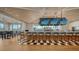Long bar with teal barstools and large screens at 21 Bayhead Ln, Osprey, FL 34229