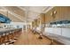 Long bar with seating, modern decor, and large TVs at 21 Bayhead Ln, Osprey, FL 34229
