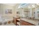 Elegant bathroom with double vanity, soaking tub, and a large mirror at 21 Bayhead Ln, Osprey, FL 34229