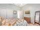 Bright bedroom with a queen bed, dresser, and a wall-mounted TV at 21 Bayhead Ln, Osprey, FL 34229
