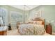 Guest bedroom with a comfortable queen-size bed and plenty of natural light at 21 Bayhead Ln, Osprey, FL 34229