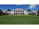 Elegant clubhouse with a classic design, situated on a lush green lawn at 21 Bayhead Ln, Osprey, FL 34229
