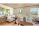Bright dining area with booths, hardwood floors, and views of the golf course at 21 Bayhead Ln, Osprey, FL 34229