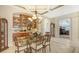 Elegant dining room featuring a glass table, wood cabinetry, and a chandelier at 21 Bayhead Ln, Osprey, FL 34229
