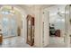 Bright entry hall with a grandfather clock and office view at 21 Bayhead Ln, Osprey, FL 34229