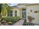 Front entrance with teal double doors and brick walkway at 21 Bayhead Ln, Osprey, FL 34229