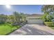 Home with a brick driveway, and palm trees in the front yard at 21 Bayhead Ln, Osprey, FL 34229