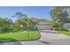 House with lush landscaping, a brick driveway, and a mailbox at 21 Bayhead Ln, Osprey, FL 34229