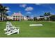White chairs on green golf course near clubhouse at 21 Bayhead Ln, Osprey, FL 34229
