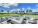 Large fire pit with comfortable seating, overlooking a golf course at 21 Bayhead Ln, Osprey, FL 34229