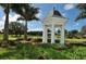 White gazebo with lush landscaping and golf course view at 21 Bayhead Ln, Osprey, FL 34229