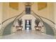 Impressive double staircase with marble flooring and ornate details at 21 Bayhead Ln, Osprey, FL 34229