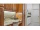 Built-in kitchen desk with granite countertop and wood cabinetry at 21 Bayhead Ln, Osprey, FL 34229