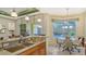Kitchen with breakfast nook overlooking the pool and lanai at 21 Bayhead Ln, Osprey, FL 34229
