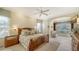 Spacious main bedroom with wood furnishings and built-in window seat at 21 Bayhead Ln, Osprey, FL 34229