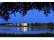 Stunning lakeside view of the clubhouse at twilight at 21 Bayhead Ln, Osprey, FL 34229