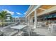 Relaxing outdoor patio with tables and chairs, overlooking a golf course at 21 Bayhead Ln, Osprey, FL 34229