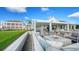 Outdoor patio with fire pit and comfortable seating, overlooking a golf course at 21 Bayhead Ln, Osprey, FL 34229