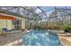 Relaxing screened pool and spa with flagstone patio and outdoor furniture at 21 Bayhead Ln, Osprey, FL 34229