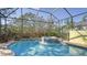 Inviting screened pool and spa with flagstone patio and lush landscaping at 21 Bayhead Ln, Osprey, FL 34229