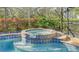 Spa with blue tile accents and a tranquil setting at 21 Bayhead Ln, Osprey, FL 34229