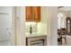 Kitchen wine cellar with granite countertop and wood cabinetry at 21 Bayhead Ln, Osprey, FL 34229