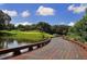 Picturesque wooden bridge over a calm body of water, leading to a golf course at 21 Bayhead Ln, Osprey, FL 34229