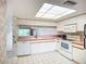 Bright kitchen featuring white appliances and cabinetry and great lighting at 4382 Madeira Ct # 3361, Sarasota, FL 34233