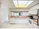 Bright kitchen featuring white appliances and cabinetry and great lighting at 4382 Madeira Ct # 3361, Sarasota, FL 34233