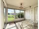 Enclosed lanai with tile floor, furniture, storage, and a view of the lawn and landscaping at 4382 Madeira Ct # 3361, Sarasota, FL 34233