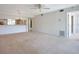 Open-concept living room with neutral carpet and views into the kitchen and dining area, creating a connected living space at 4382 Madeira Ct # 3361, Sarasota, FL 34233