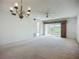 Bright living room with ceiling fan and access to a screened lanai with beautiful views of the outdoor landscape at 4382 Madeira Ct # 3361, Sarasota, FL 34233