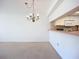 Spacious living room next to kitchen with a hanging light fixture and neutral carpet at 4382 Madeira Ct # 3361, Sarasota, FL 34233