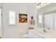 Clean bathroom with a toilet, sink, and shower, featuring white cabinets and a large mirror at 735 Shadow Bay Way, Osprey, FL 34229