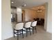 Elegant kitchen featuring a breakfast bar and a stainless steel refrigerator at 8191 Varenna Dr, Sarasota, FL 34231