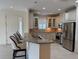 Bright kitchen with stone countertops, stainless steel appliances, and ample cabinetry at 8191 Varenna Dr, Sarasota, FL 34231