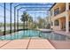 Stunning screened-in pool with spa and serene lake views in this elegant home at 9452 Swaying Branch Rd, Sarasota, FL 34241