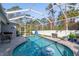 Inviting screened pool area with a kidney-shaped pool at 14308 Tugwell Ave, Port Charlotte, FL 33953