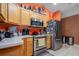 Clean kitchen with stainless steel appliances and wood cabinets at 14308 Tugwell Ave, Port Charlotte, FL 33953