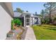 Inviting home exterior with a landscaped walkway and lush greenery at 14308 Tugwell Ave, Port Charlotte, FL 33953