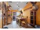 Rustic dining area with a unique stone accent wall and wooden furniture at 14308 Tugwell Ave, Port Charlotte, FL 33953