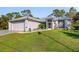 Single-story home with attached garage and manicured lawn at 14308 Tugwell Ave, Port Charlotte, FL 33953